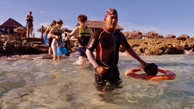 Snorkeling guide leading small group over reef in Varadero Cuba