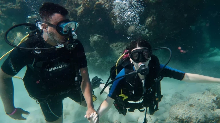 Two beginner divers enjoying first scuba diving experience together in Varadero